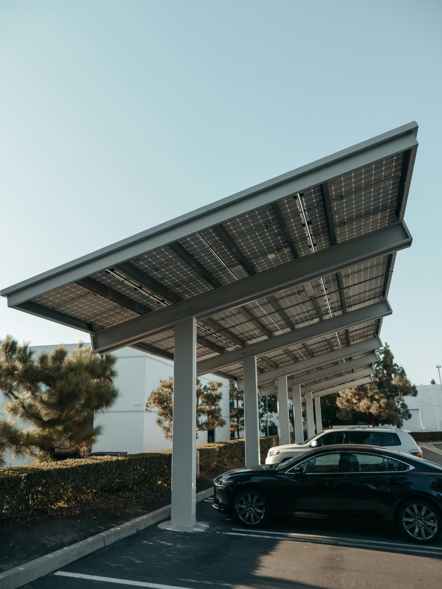 Cantilever solar carport with panels overhead in a commercial car park
